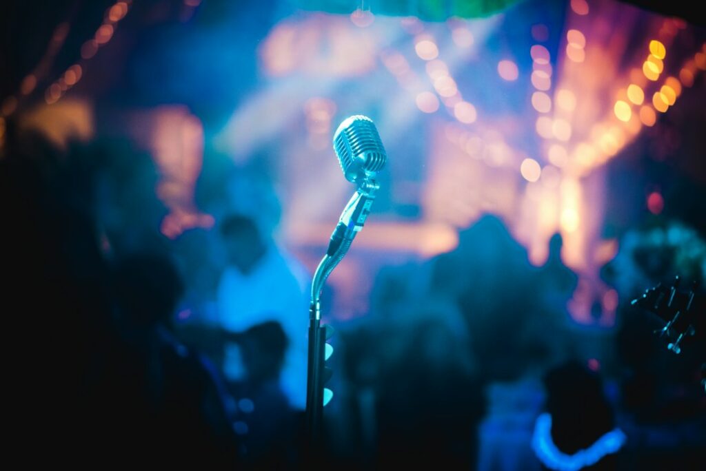 Illustrative microphone and stage scene, not RAYE or the Mercury Prize
