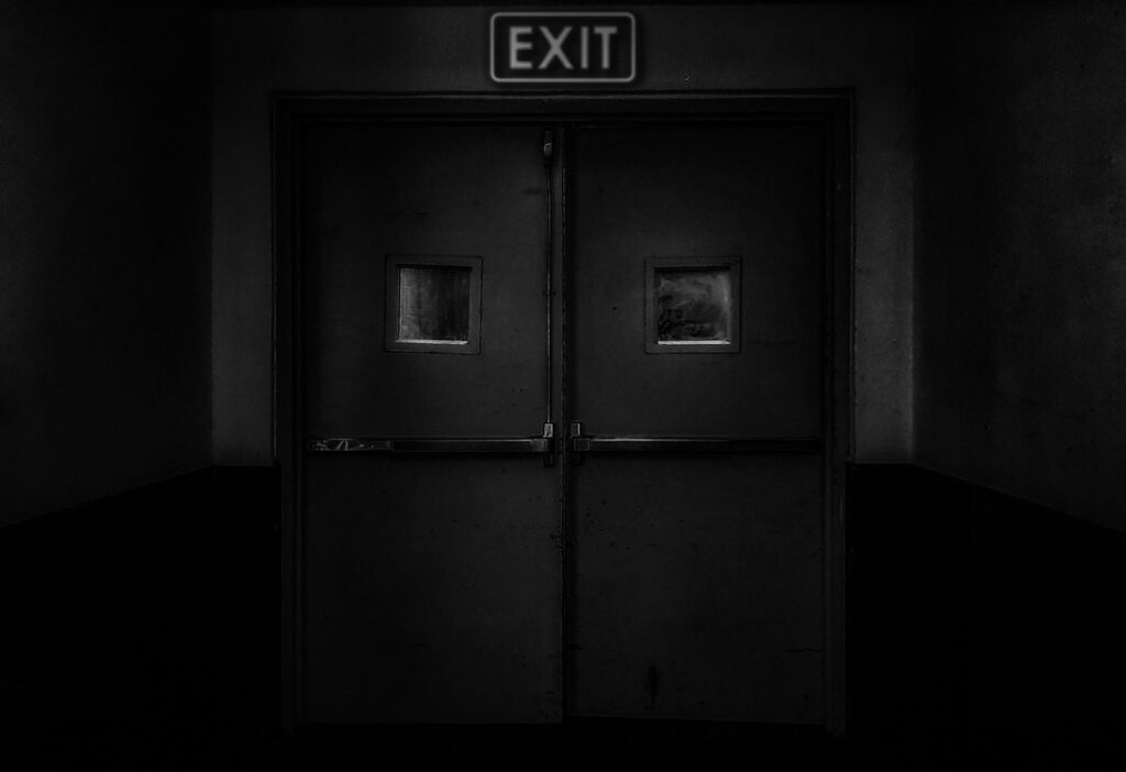 Illustrative atmospheric exit sign, not a still from American Horror Story