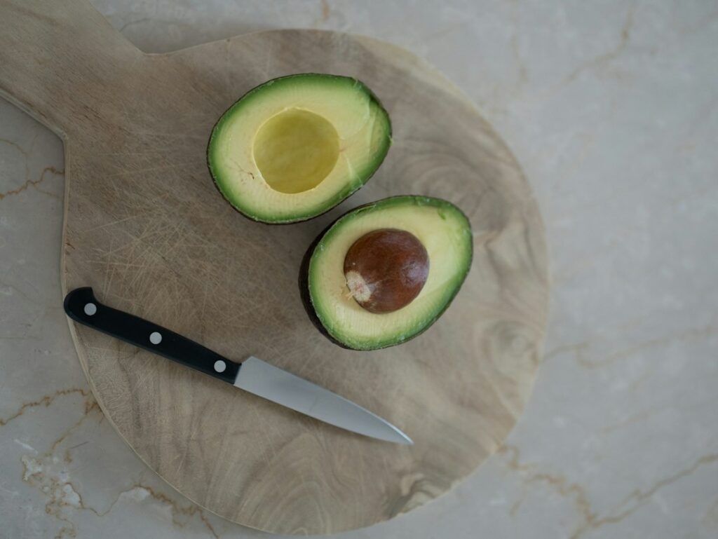 Freshly cut avocado with pit; illustration not the stringy avocado in story