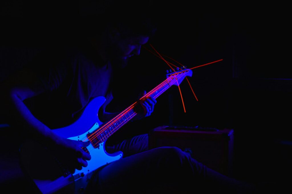 Illustrative musician in dramatic stage light; not LISA